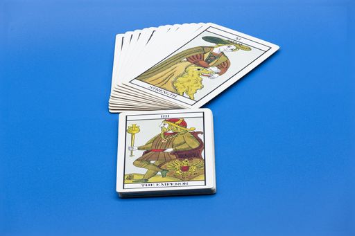 A stack of tarot cards on blue surface