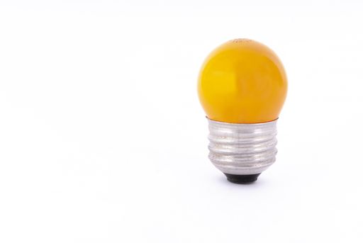 A yellow light bulb isolated on a white background