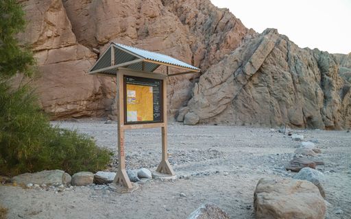 A sign post marks the trailhead for the Painted Canyon and Ladder Canyon trails in the Mecca Hills Wilderness area near Palm Springs.