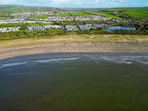 A scenic aerial shot of Par Beach in Cornwall. A costal town near the sea
