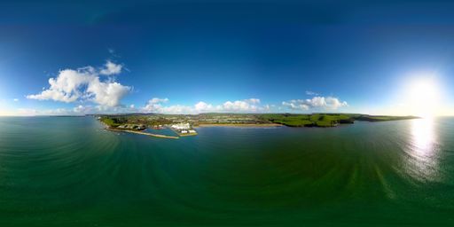 A 360-degree panoramic shot of the green sea and land against the background of the blue sky.