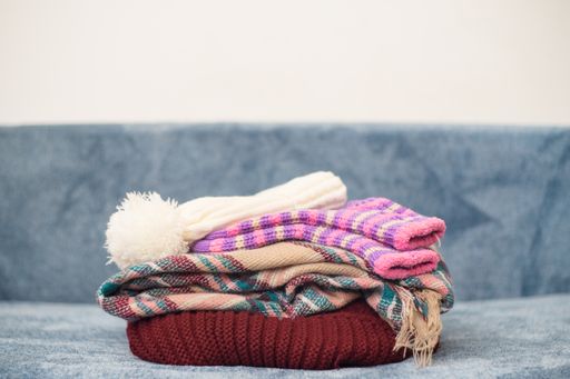 A closeup of stacked warm winter clothes