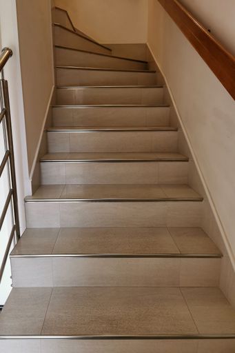 Close-up of white staircase in private house. Modern interior. Clean steps.