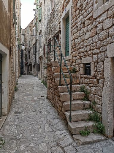A vertical shot of old narrow streets and stone stairs in Sibenik, Croatia