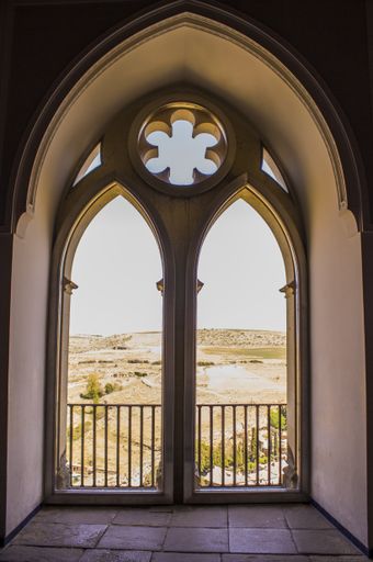 A vertical shot of a window in the castle of Segovia, Spain