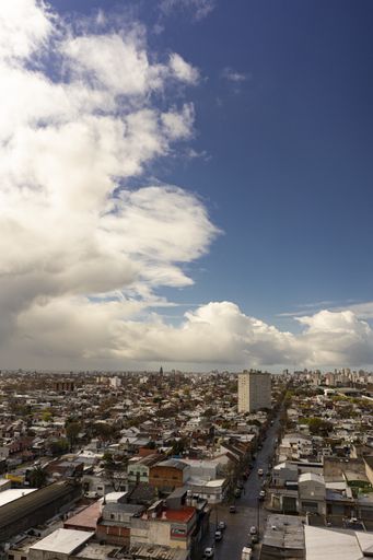 A vertical shot of a beautiful cityscape under a cloudy sky