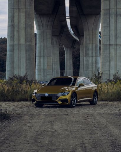 A vertical shot of a Volkswagen Arteon gold color