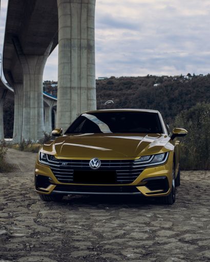 A vertical shot of a Volkswagen Arteon gold color