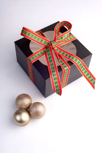 A gift bow with a red and green bow and baubles isolated on white