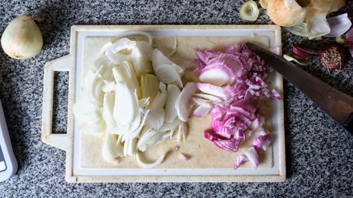 A top view of sliced onion on a cutting board