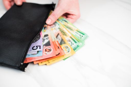 the Australian dollar banknotes in a black wallet on the white background