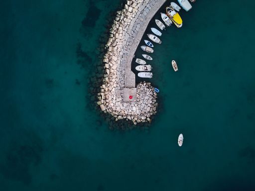 An aerial top view of boats moored on the dock in Fazana, Croatia