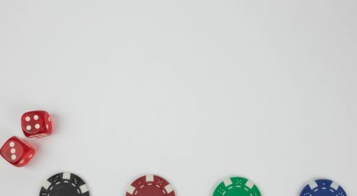 the red dices with white dots and poker chips on a white background