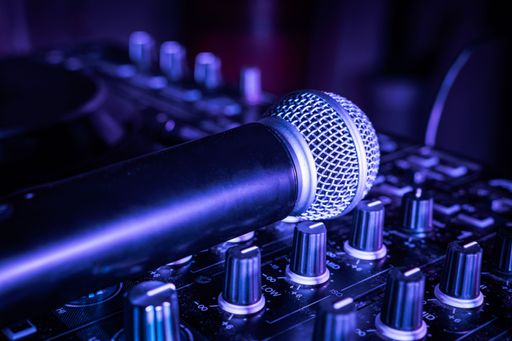 A close-up shot of a wireless microphone on an audio mixer