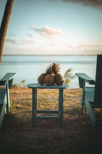 A vertical shot of pineapples on a table on the beach in Moorea, French Polynesia