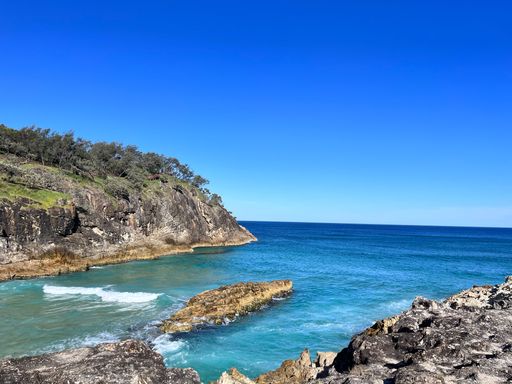 The beautiful view of the sea and cliffs against the background of the blue sky.