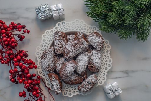 A top view of chocolate cookies with Christmas decorations around