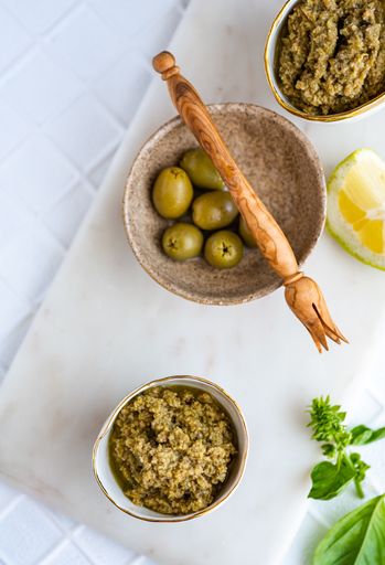 A top view of a green olive Tapenade on white background