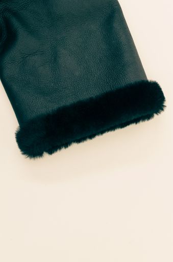 A vertical top view shot of a coat sleeve on an isolated white background