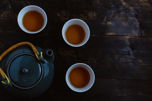 A top view of a gray tea set on dark wooden background