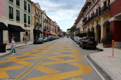 The West Palm Beach street view, parked cars, Christmas lights, colourful buildings, daytime
