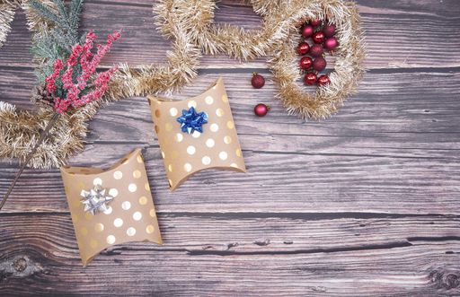 A flat lay of Christmas boxes on wooden background