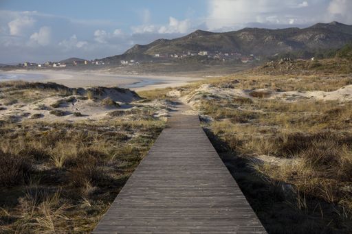 A beautiful shot of a footpath leading to Larino Beach in Galicia Spain