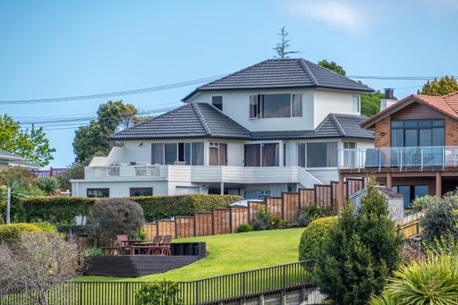 View of typical New Zealand suburban house with mowed lawn in front