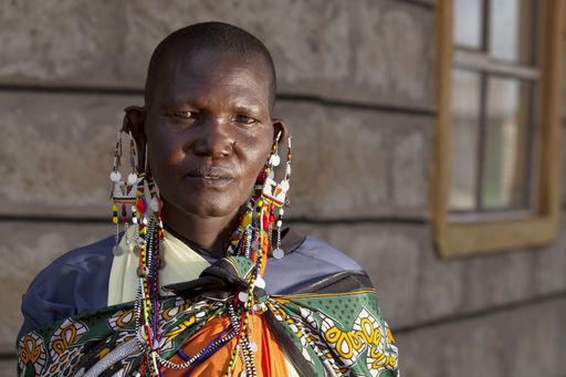 A shallow focus shot of an African person wearing big earrings while looking at the camera