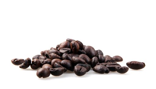 A closeup shot of coffee beans isolated on a white background