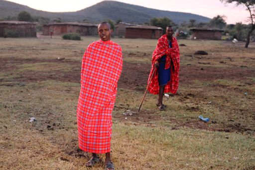 A shallow focus shot of an African male wrapped around in a blanket