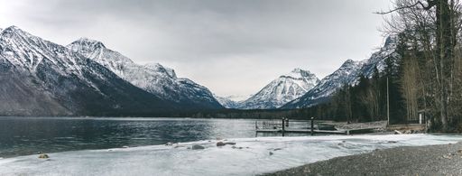 Beautiful Lake in Glacier National Park with snow capped mountains in the background in Montana