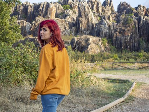 A closeup shot of a young attractive lady with red hair posing in Cerro del Hierro, Sevilla, Spain