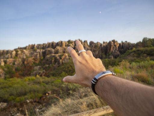 A closeup shot of a male's hand reaching for a canyon in Cerro del Hierro, Sevilla, Spain