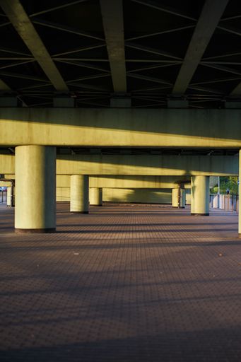 A vertical shot of an empty two-story parking lot with columns
