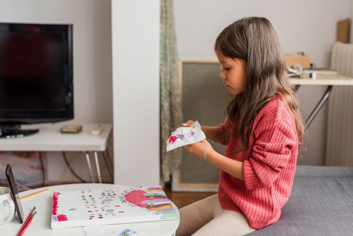 A shallow focus of a Hispanic little girl learning from home