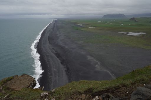 A high angle shot of Reynisfjara black beach in Iceland against the sea on a cloudy day