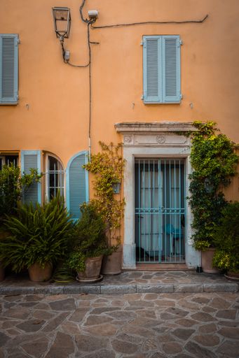 A doorway of a building in the beautiful old town of Bormes-Les-Mimosas, France during a summer evening.