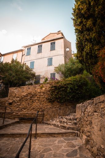 A building in the beautiful old town of Bormes-Les-Mimosas, France during a summer evening