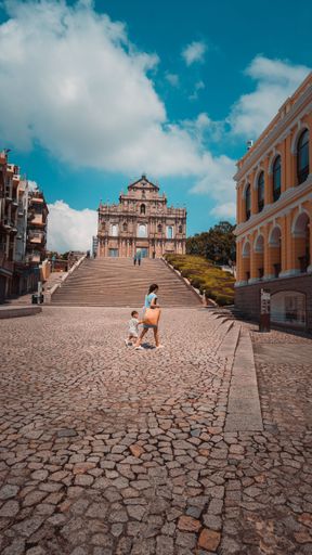 A vertical shot of the lonely ruins of St Paul's in Macau in cloudy sky background