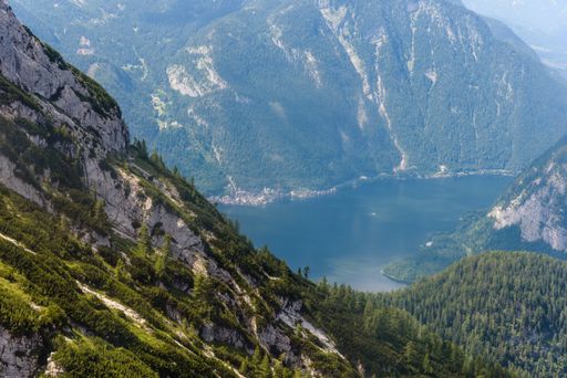 An aerial shot of a lake surrounded by mountains in Hallstatt, Austria