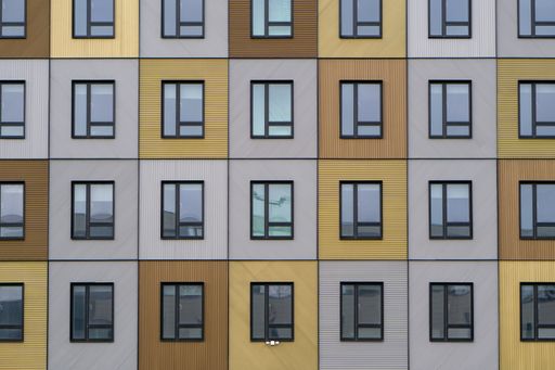 The beautiful wooden facade of a modern building reflecting the sky
