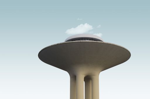 A low angle shot of an exotic modern structure under the clouds in the sky