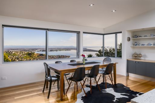 A trendy house interior with modern furniture and glass windows