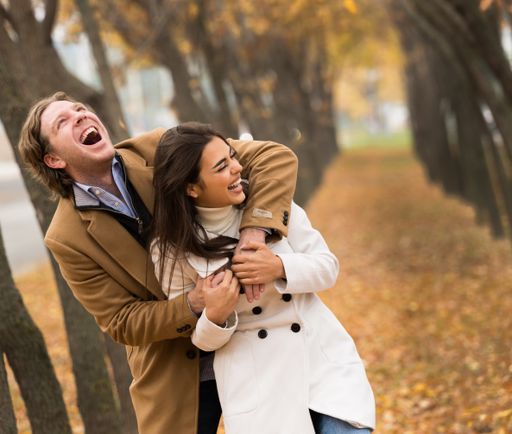 A loving Caucasian couple walking in the park in fall