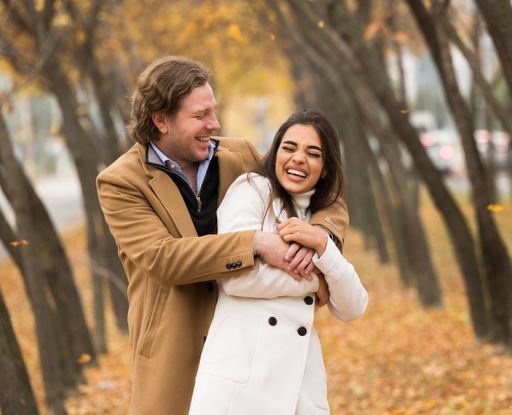 A loving Caucasian couple walking in the park in fall