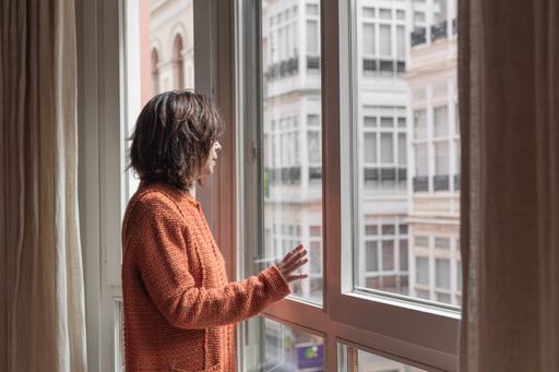 A female looking out of window