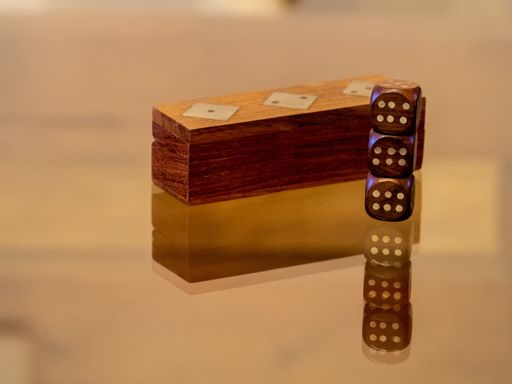 A closeup shot of wooden cubic dices and a wooden case