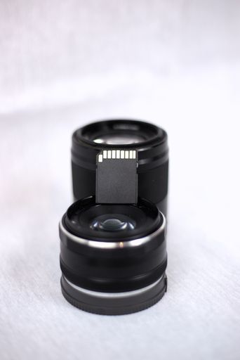 A vertical closeup shot of camera photo lens isolated on a white background