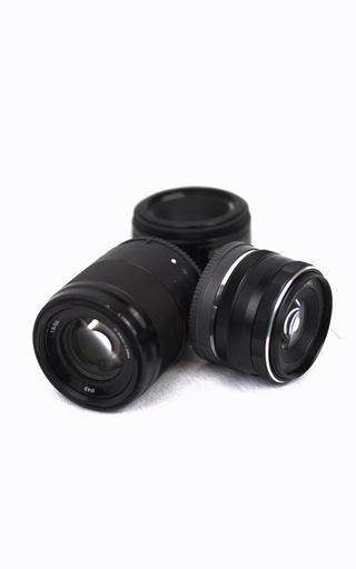 A vertical closeup shot of camera photo lens isolated on a white background